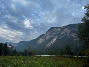 Weite Berglandschaft mit bewaldeten Hängen entlang der Alpe-Adria-Route, stille Alpenkulisse